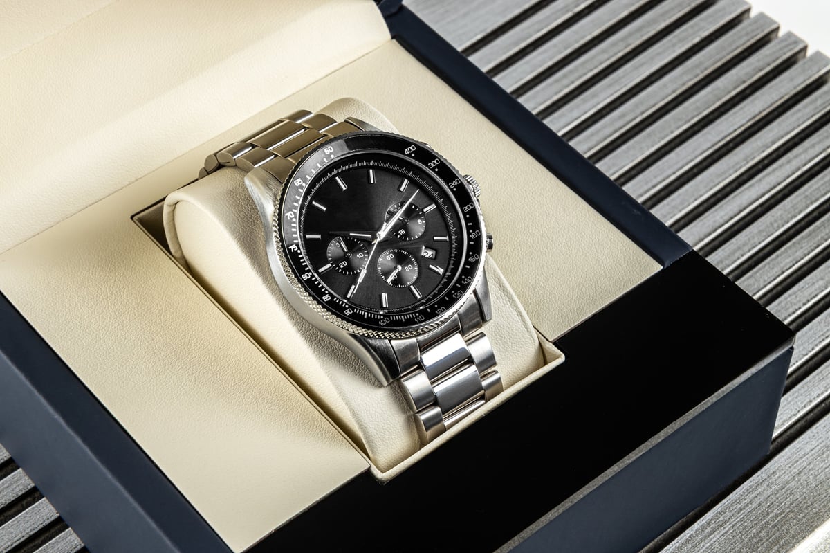 Modern men's wristwatch with black dial, gray stainless steel bracelet