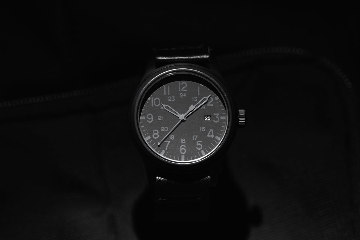 Black analog wristwatch with minimalist monochrome dial